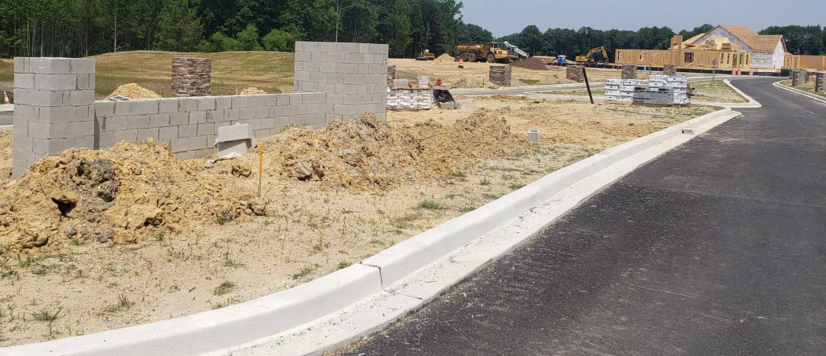 The main entrance has concrete slaps stacked and constuction debris strewn about.